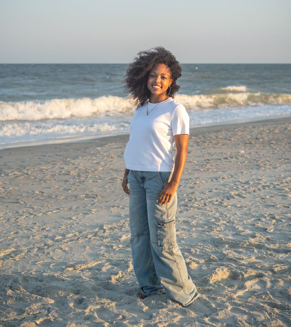 The founder of The Cookie Drop, smiling on the beach